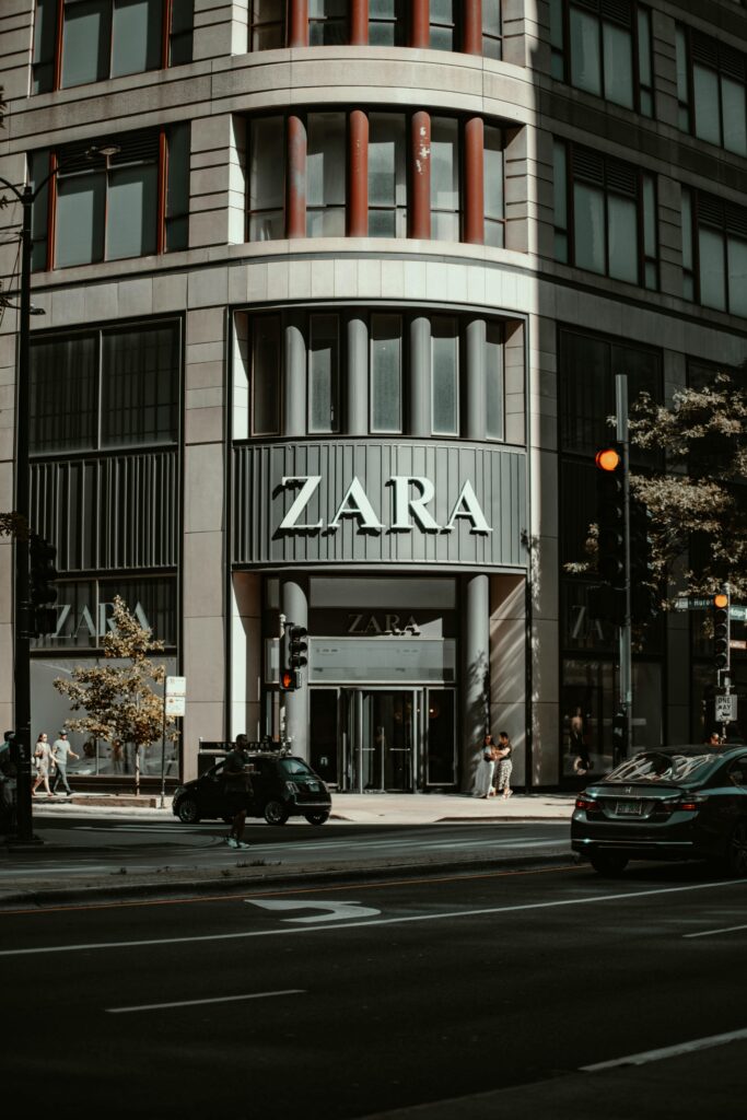 A vibrant urban street scene in Chicago with prominent Zara storefront and people.